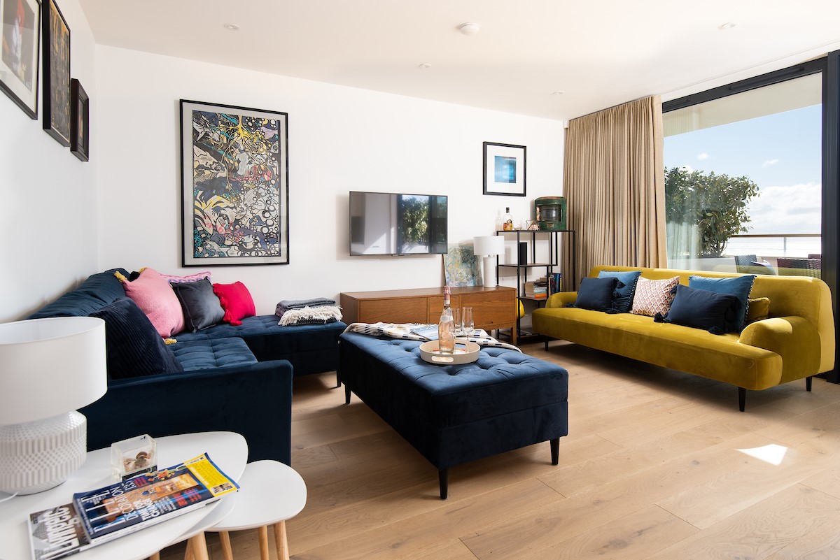 7 The Bay, Coldingham - the rich colours in the sitting area contrast beautifully with the whitewashed walls and minimalist design of the apartment