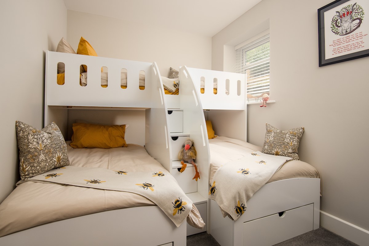 Roundhill Coach House - the charming bespoke bunk bedroom with three small single beds