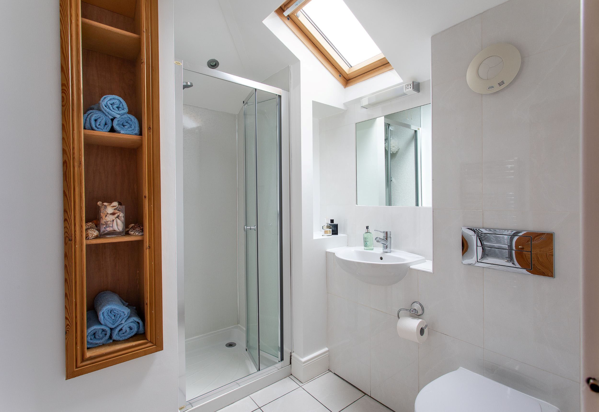 Sea Breeze - en-suite shower room with shower, WC and basin with mirror above