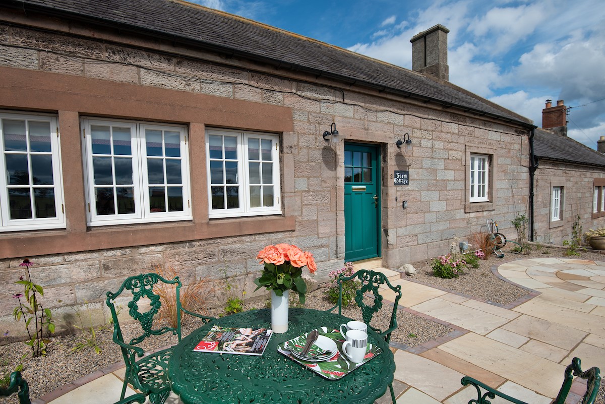 Farm Cottage - front external view of the cottage with patio garden and garden furniture