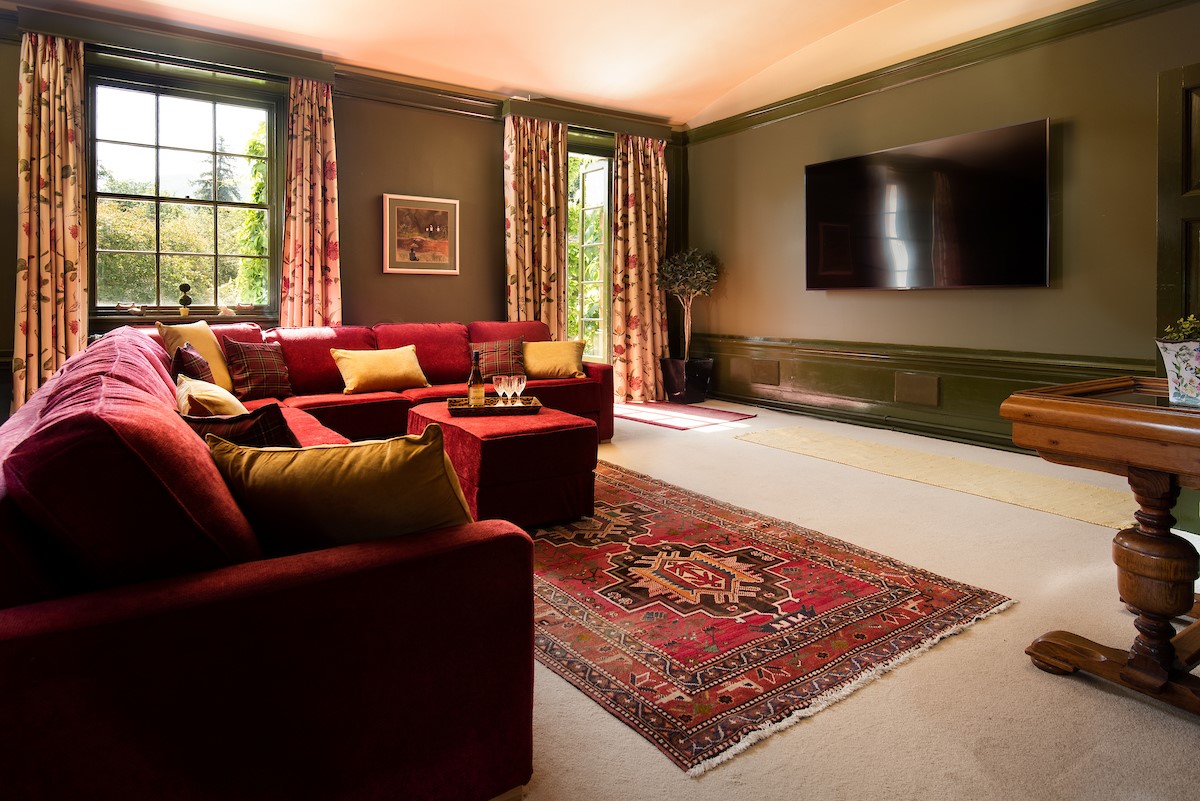 Fairnilee House - cinema room with 86" cinema TV with surround sound and French doors leading to the terrace