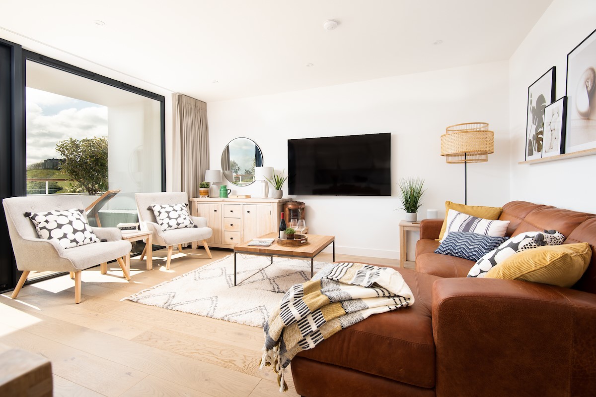 6 The Bay, Coldingham - the light-filled living space features a wall-mounted 65" Smart TV to lounge in front of after a fun-filled day out