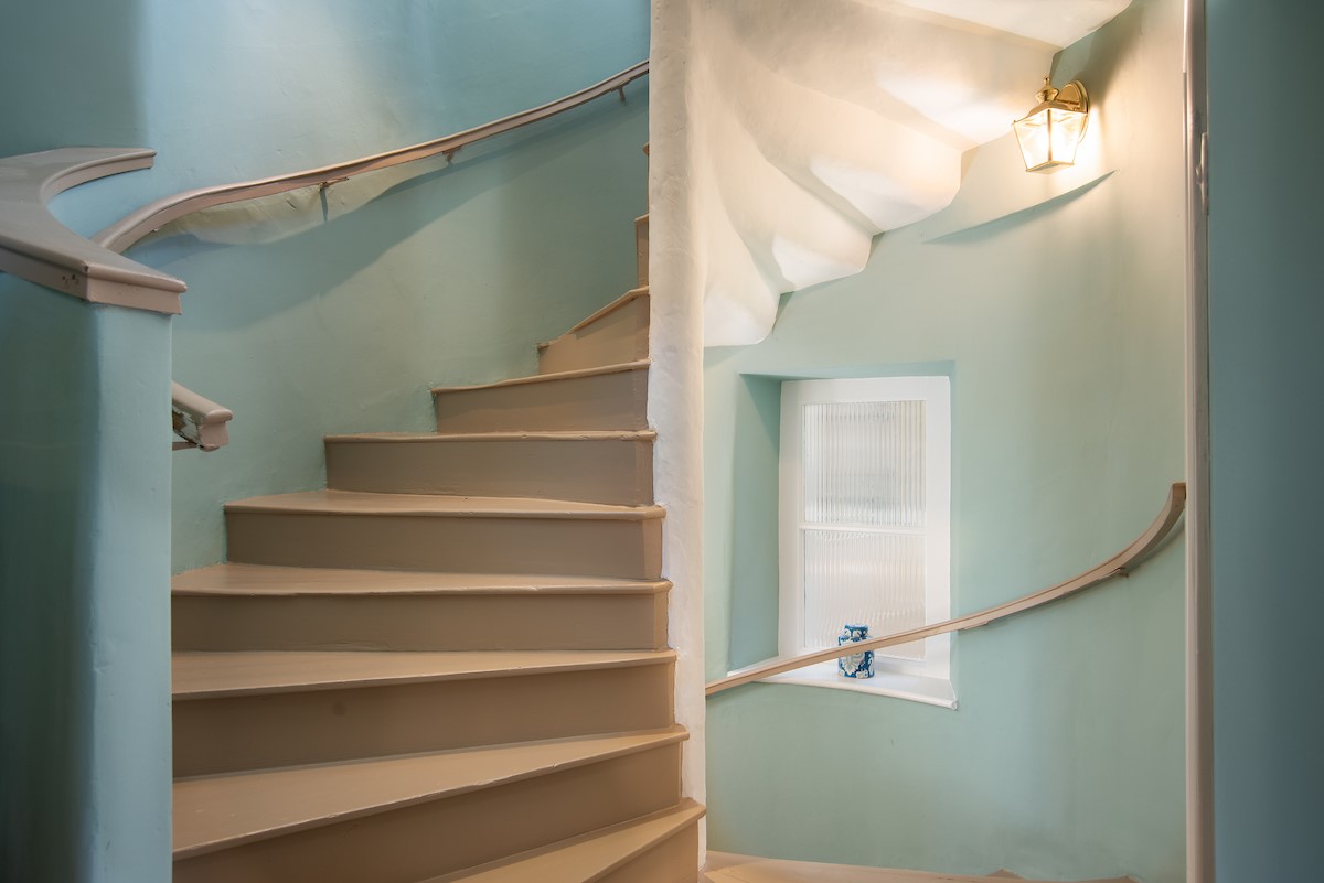 The Tower, Keith Marischal - spiral staircase leading to the first floor, painted a soft aqua