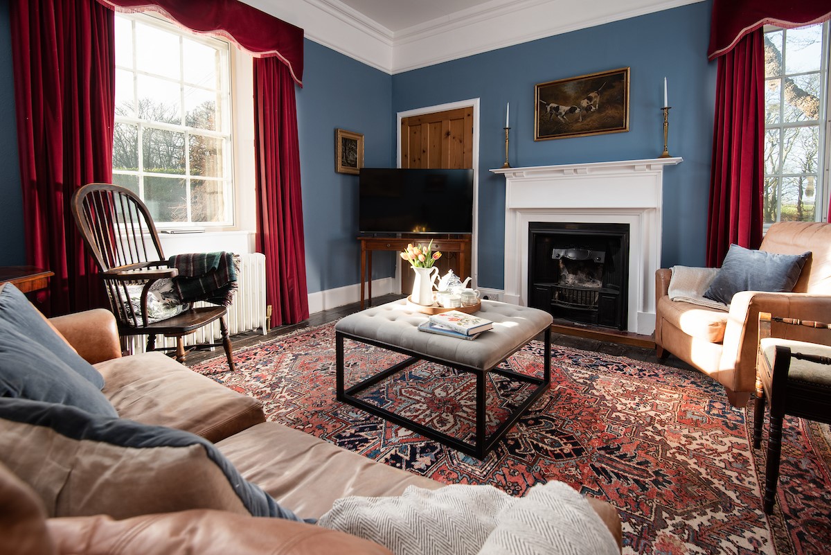 The Old Vicarage - decorative fireplace, leather sofa and armchair in the snug