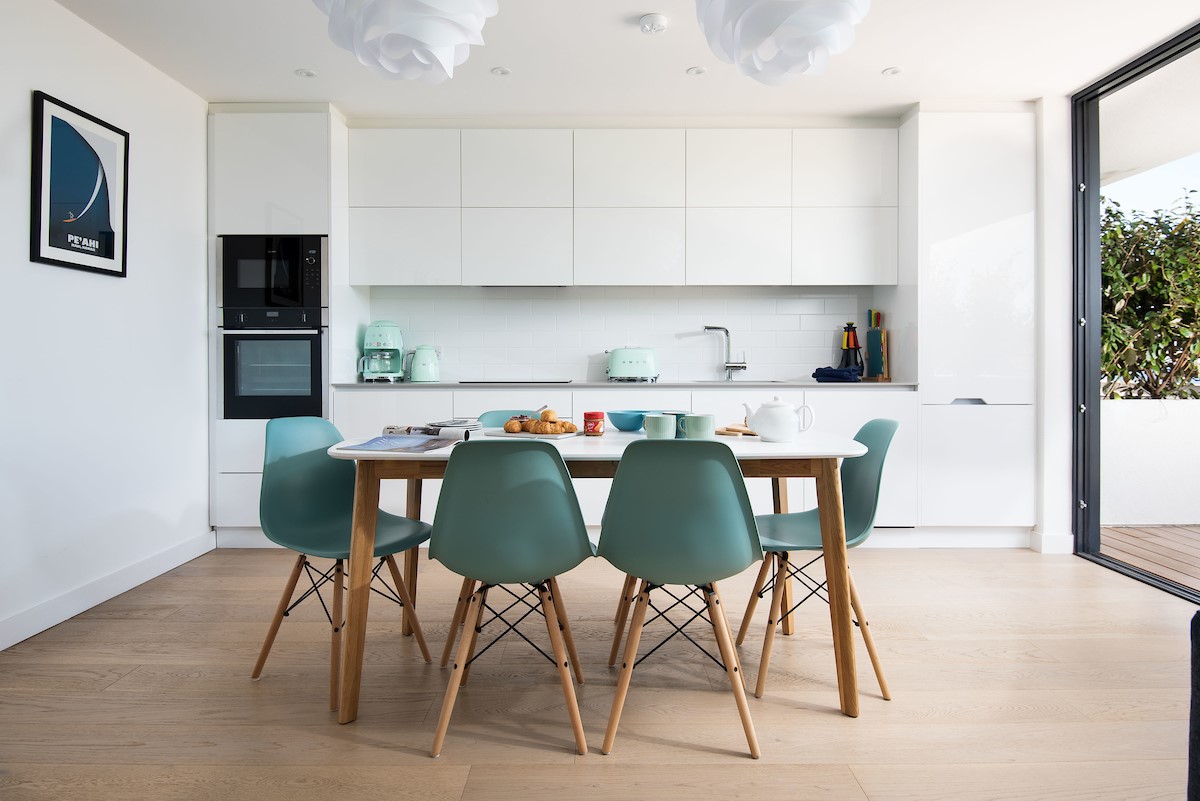2 The Bay, Coldingham - the sea view kitchen and dining area combines a streamlined high-gloss kitchen with dining table to seat six
