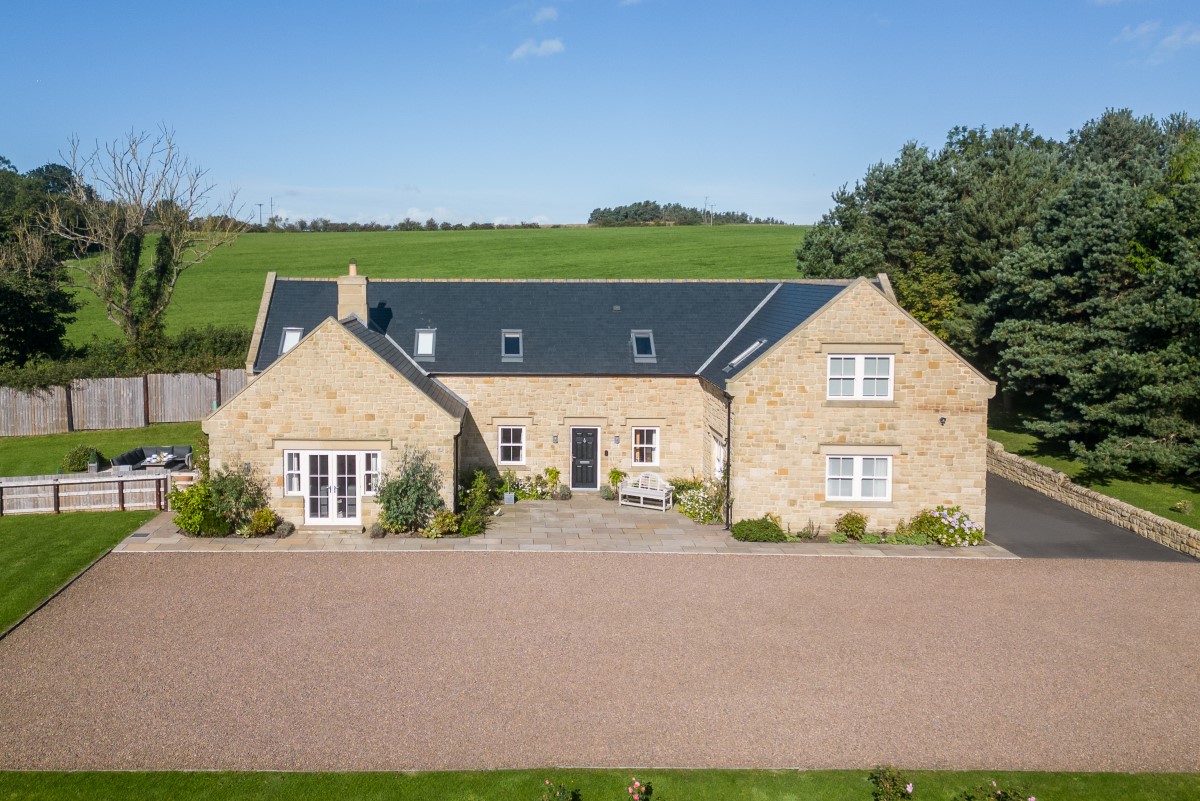 Bracken Lodge - front aspect of the property with large gravelled driveway and sheltered terrace at the front entrance
