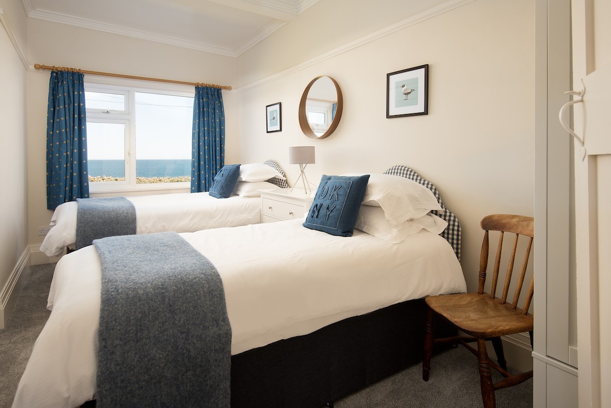 The Fairway - bedroom three with 3' twin beds, chest of drawers, wardrobe and benefiting from sea views