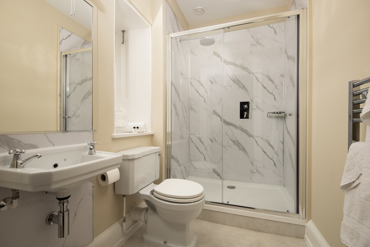 The Linen House - adjoining shower room to bedroom four features a large walk-in shower