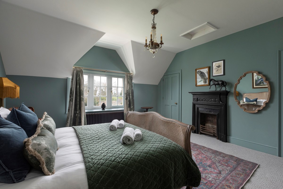 Gardener's Cottage, Twizell Estate - king size bed, decorative fireplace, mirror and storage cupboard in bedroom two