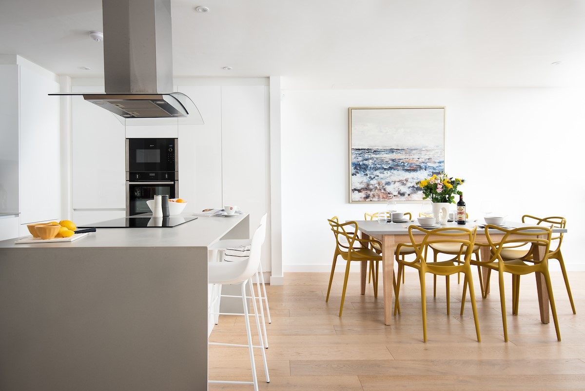 1 The Bay, Coldingham - stylish open-plan kitchen with central island and breakfast bar seating to complement the dining area