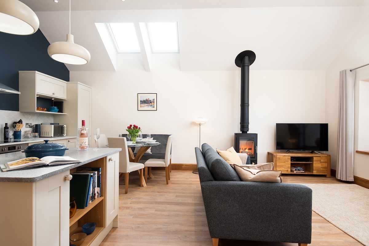 Hiddenhus - the wood burner is a striking focal point of this modern living space