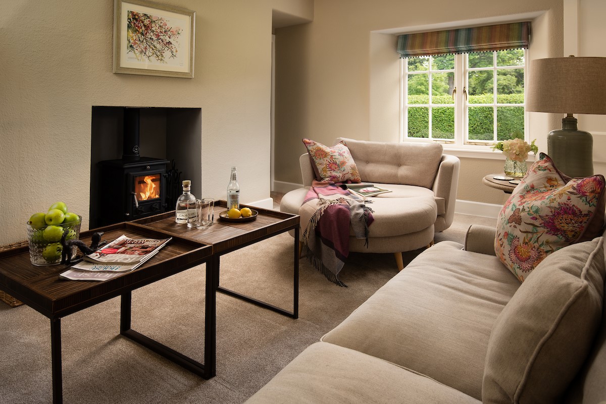 Laurel Cottage - sitting room with large sofa and snuggle seat