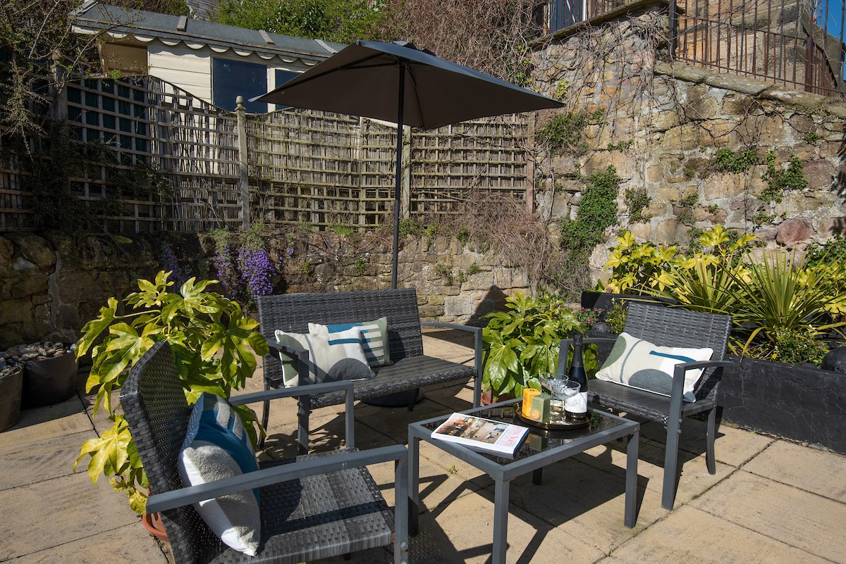 Marine House Cottage - outdoor table and chairs on the upper terrace for afternoons in the sun
