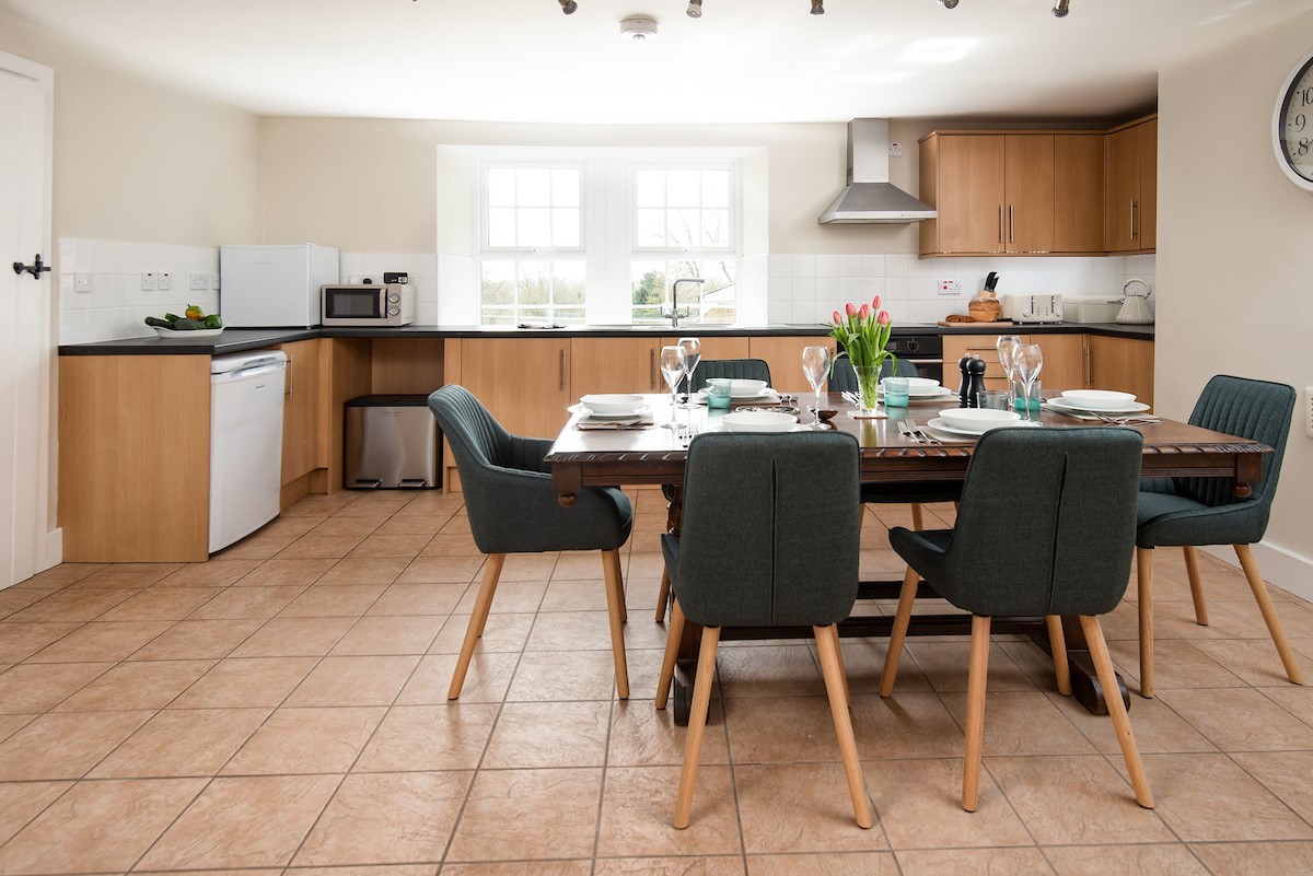 Grange House - well-equipped kitchen and large mahogany dining table, ideal for enjoyed tasty homemade meals with the family