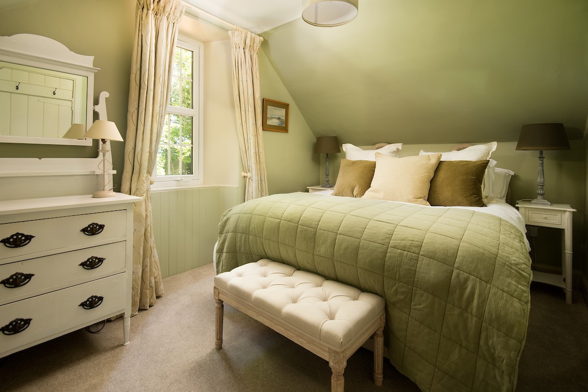 Wood Cottage - bedroom two with zip and link beds, bedside tables and chest of drawers with mirror