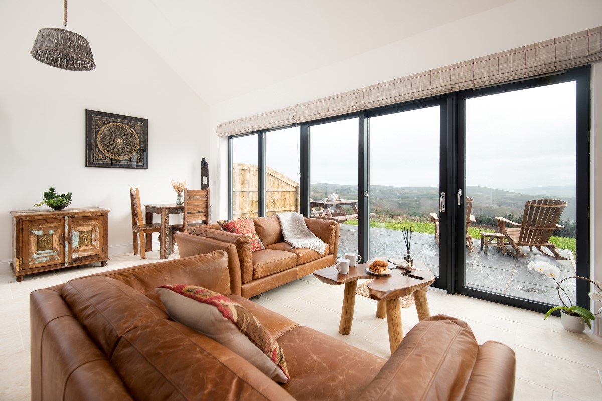 The Oak - open plan living and dining area with bi-fold doors leading onto the patio area
