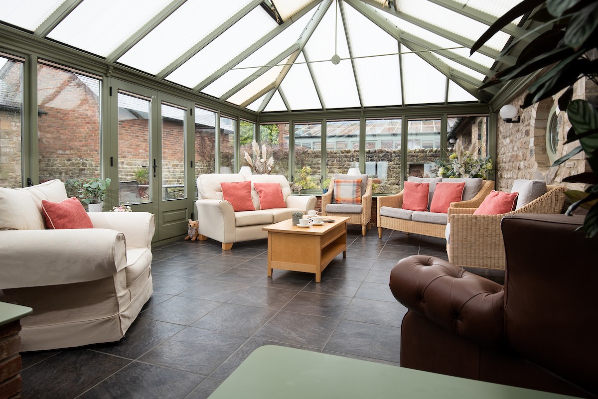 East Lodge - the light filled conservatory with direct access to the courtyard garden