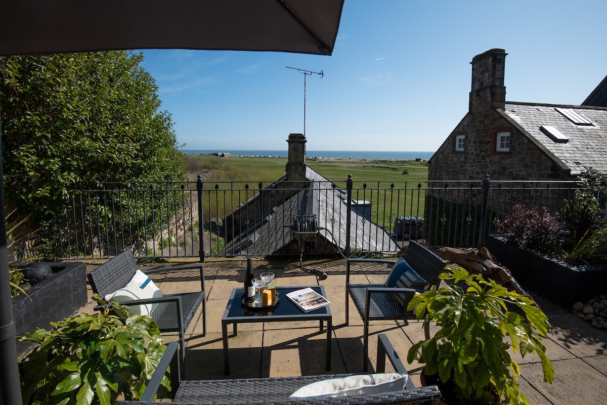 Marine House Cottage - garden furniture on the upper terrace, the perfect spot for a meal or a glass of wine whilst taking in the views
