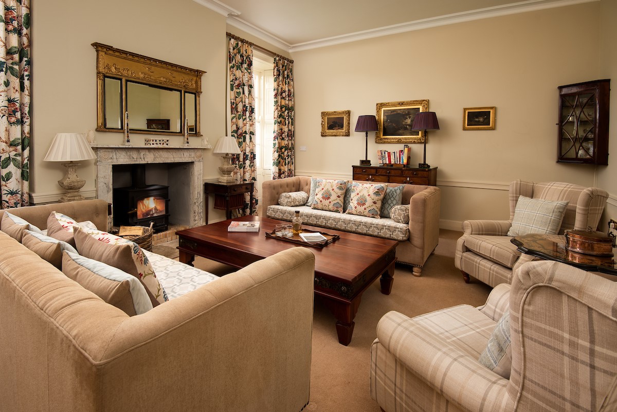 East House - the drawing room with classic detailing and generous seating set around the fireplace