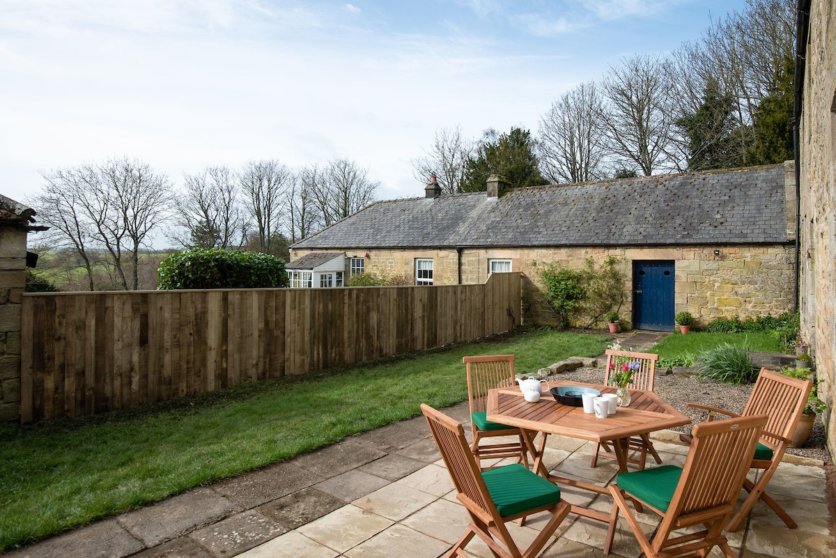 Grange House - enjoy al fresco meals on the patio with outdoor dining table seating five guests