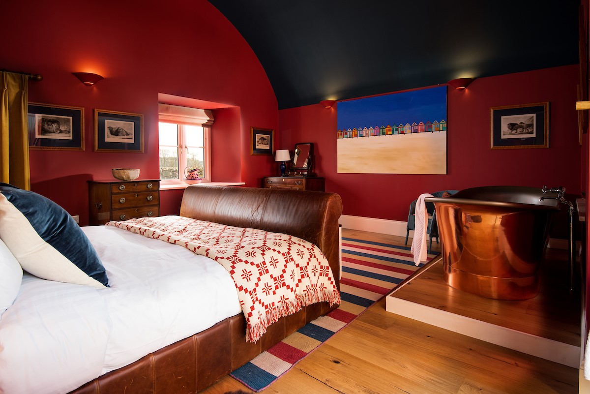 Lakeside Cottage - Edward - the bedroom is a deep sophisticated red with contrasting rich navy arched ceiling