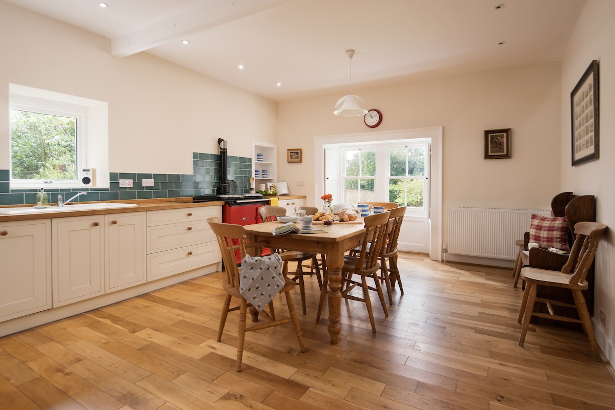 The White House - large open kitchen with dining table and pew bench where guests can socialise together