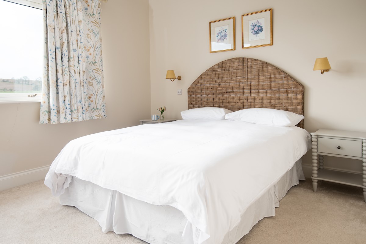 Riverhill Cottage - bedroom two - master bedroom with double bed with bedside tables