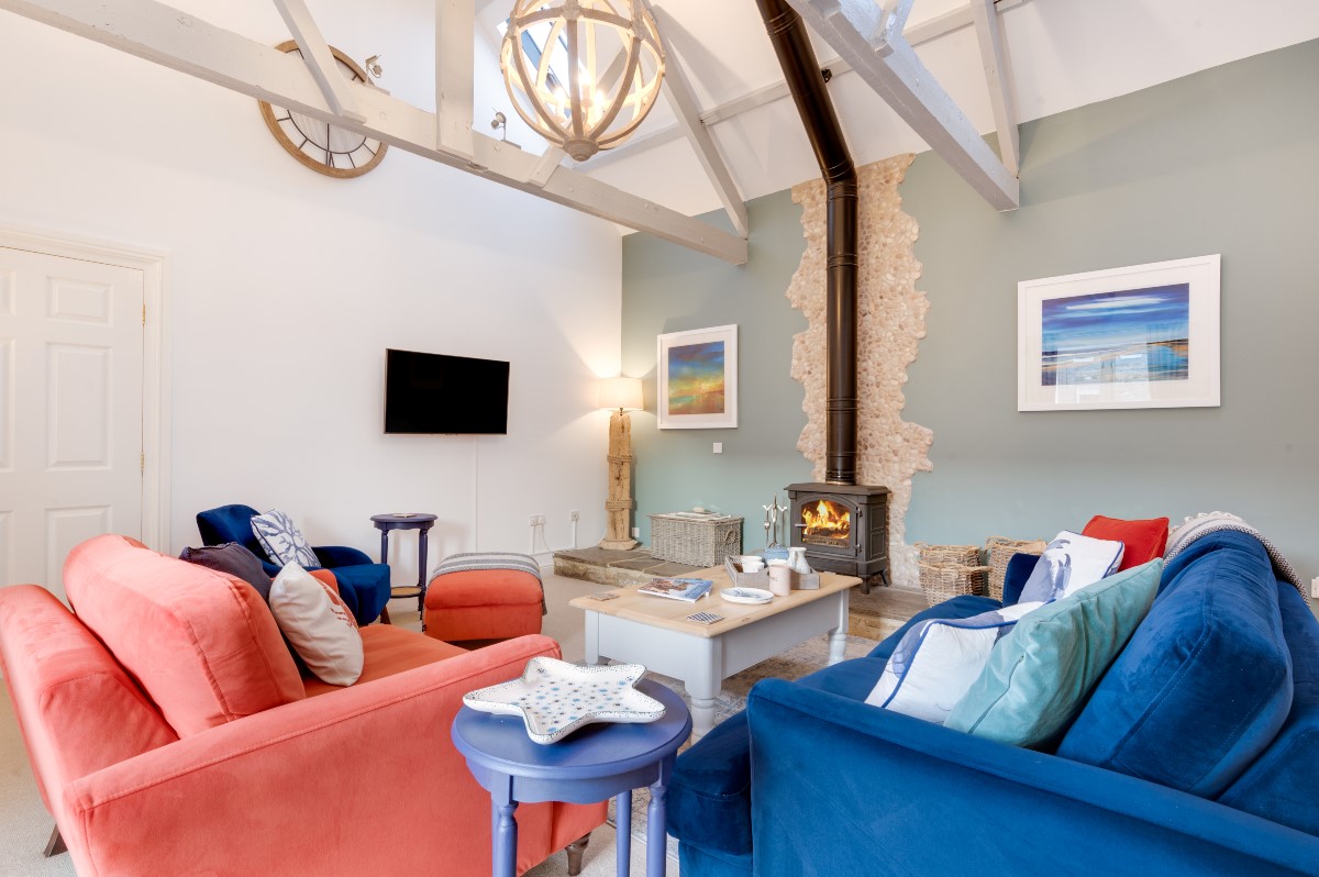 Samphire Barn - cosy sitting room with log burner, four-seater sofa, two-seater sofa and Smart TV