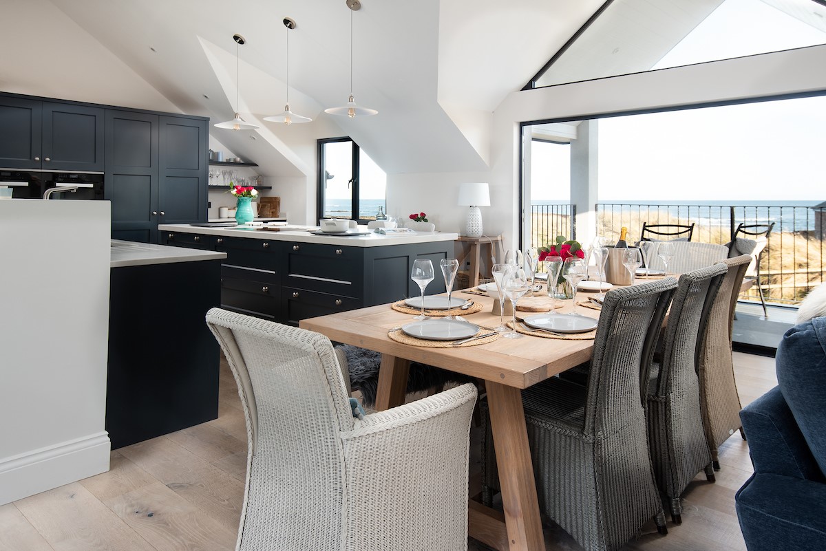 Seaside House - open the large bi-fold doors onto the front balcony to enjoy a gentle sea breeze while dining