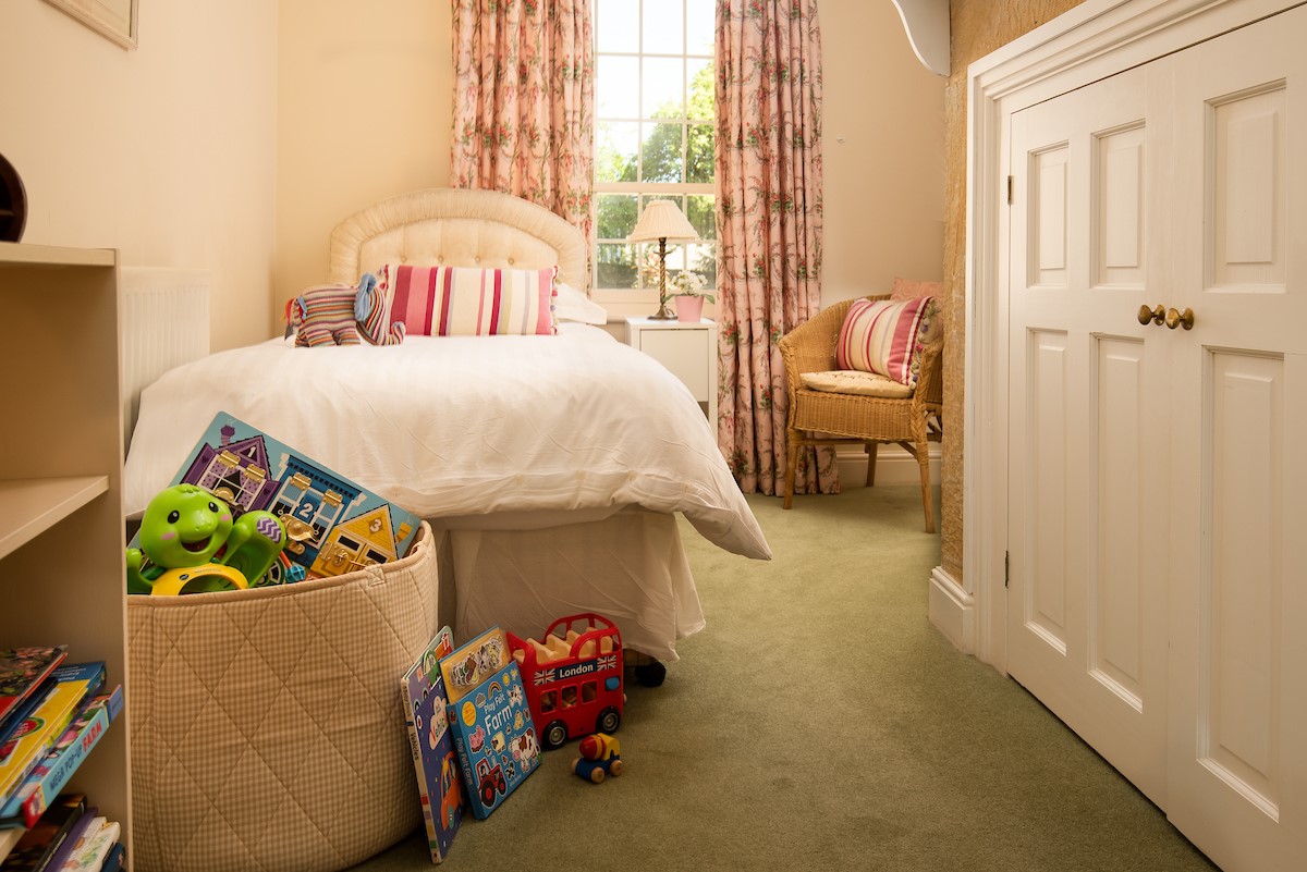 Eslington Lodge - bedroom four with single bed and built in wardrobe and children's games