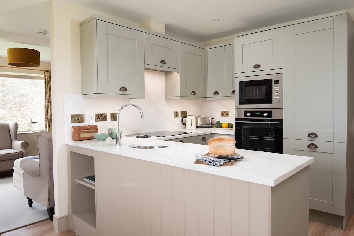 Bee Cottage - kitchen with in-built oven and microwave, electric hob, and fridge/freezer