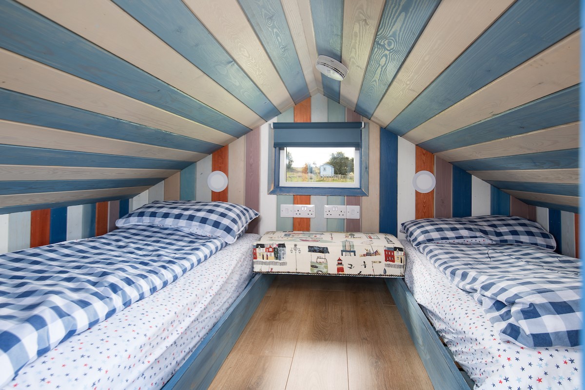 Berrington Beach Hut - upper floor bedroom has a beachy feel with twin beds
