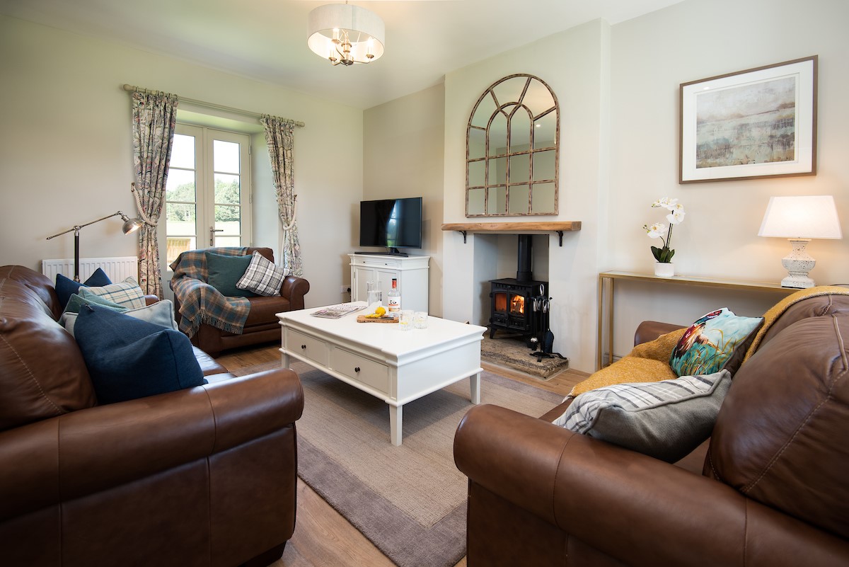 Lookout Cottage - unwind on the comfortable sofas infront of the multi-fuel stove
