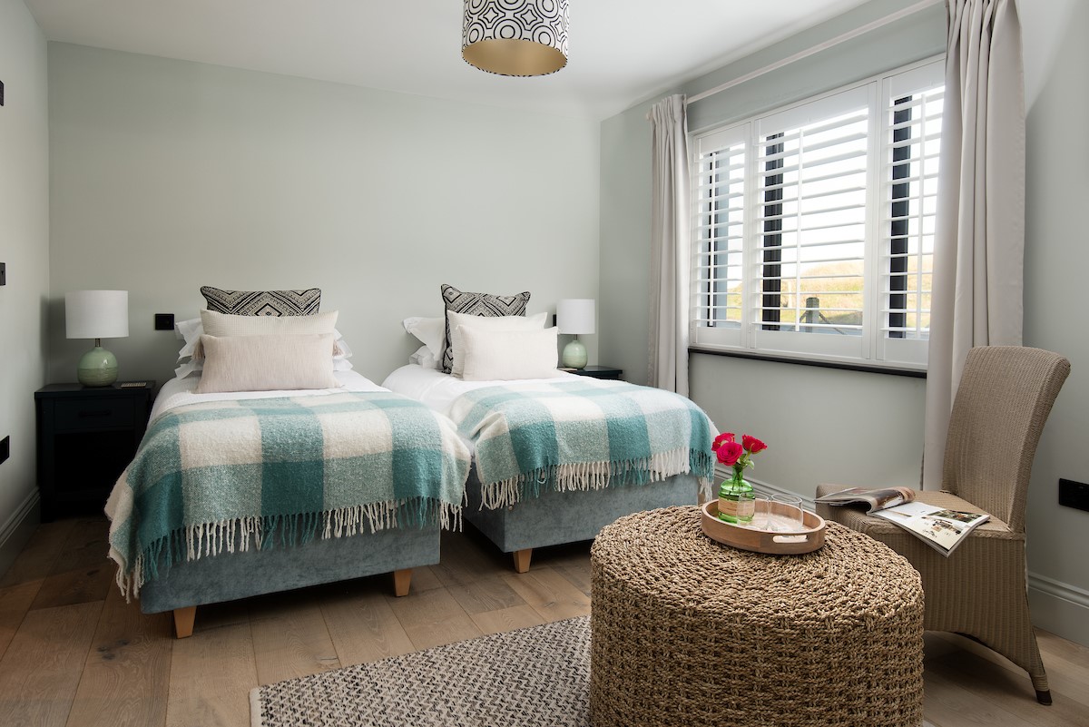 Seaside House - bedroom four with twin single beds that can be configured as a super king upon request
