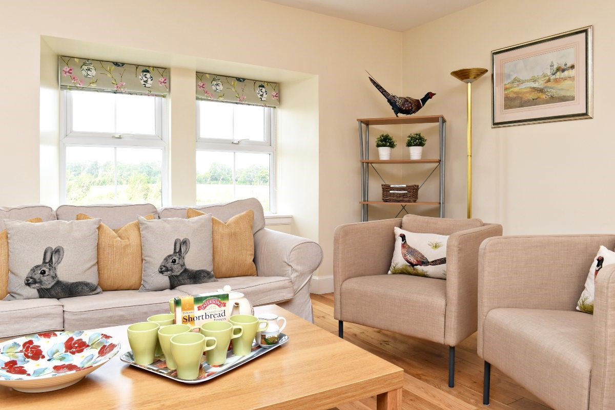 Hawthorn House - sitting room with comfortable sofa and pair of single armchairs