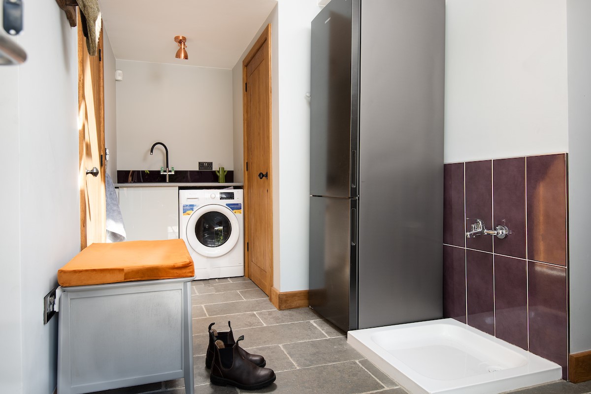 The Forge - boot room and utility area with shower tray and tap to rinse off sandy feet