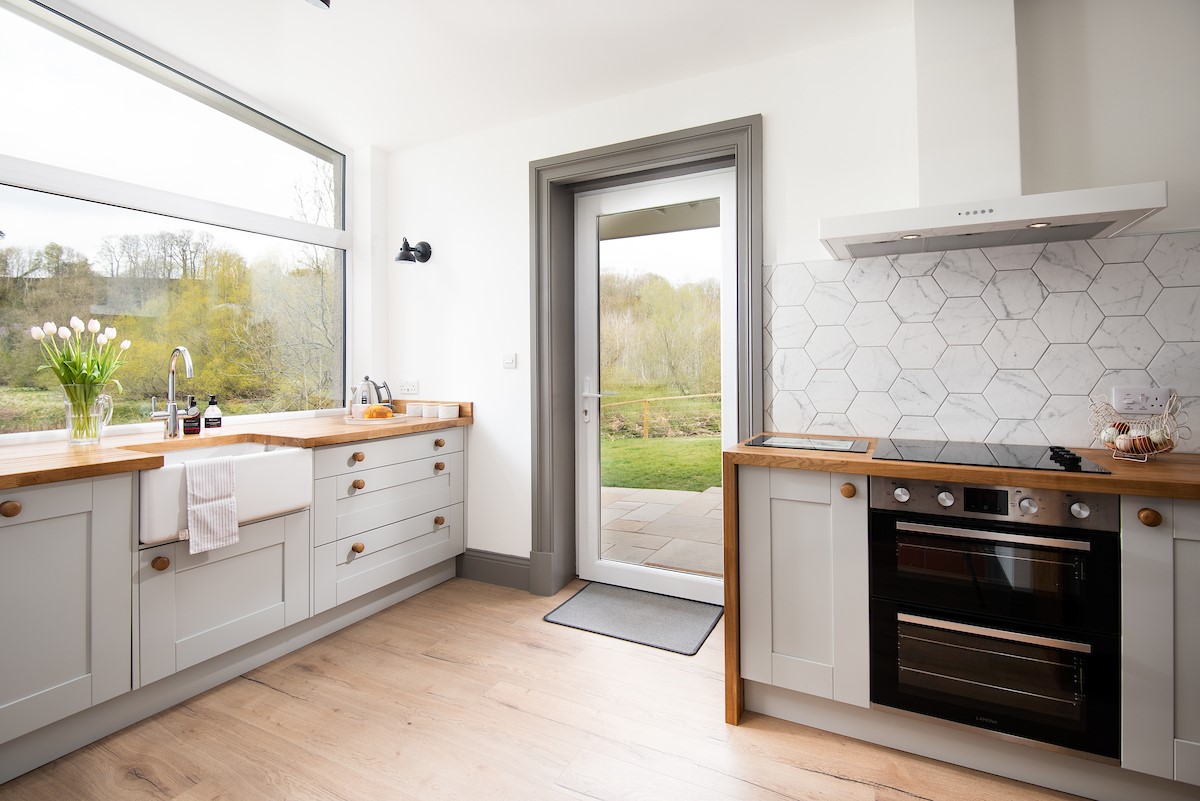 West Mill Cottage - the bright and airy kitchen benefits from a large window and door to the rear garden