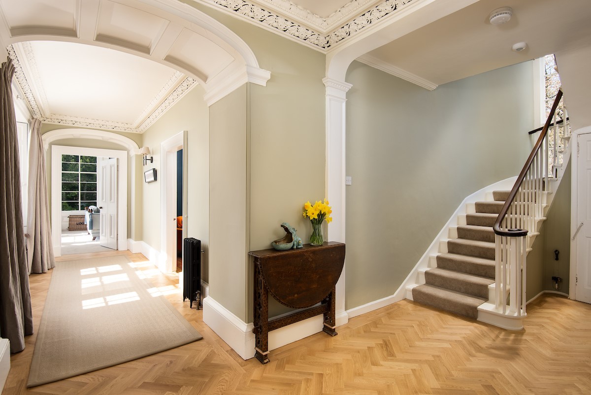 Cairnbank House - access into the light filled access hall with parquet flooring and central staircase