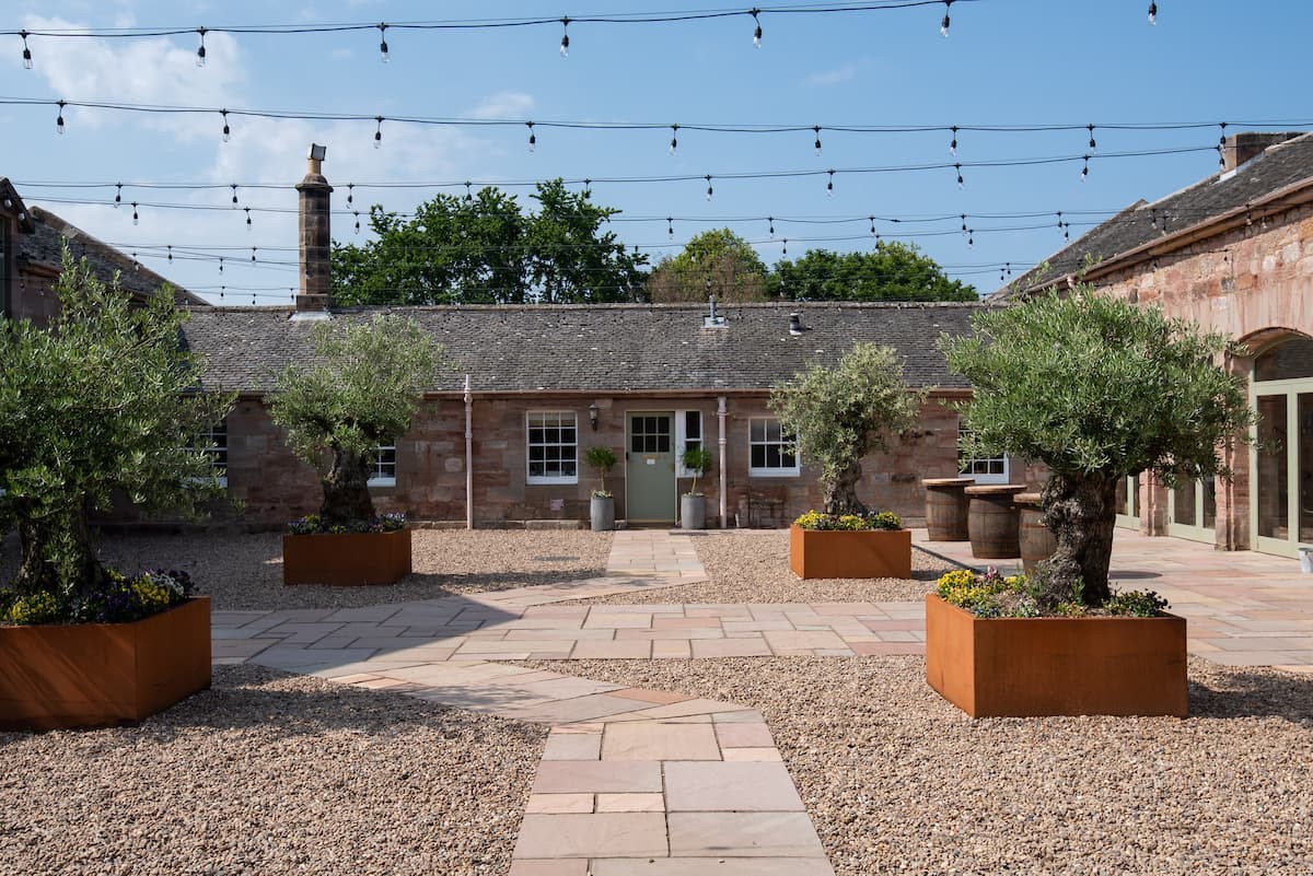 Willow Cottage - courtyard to the front of the property with atmospheric festoon lighting