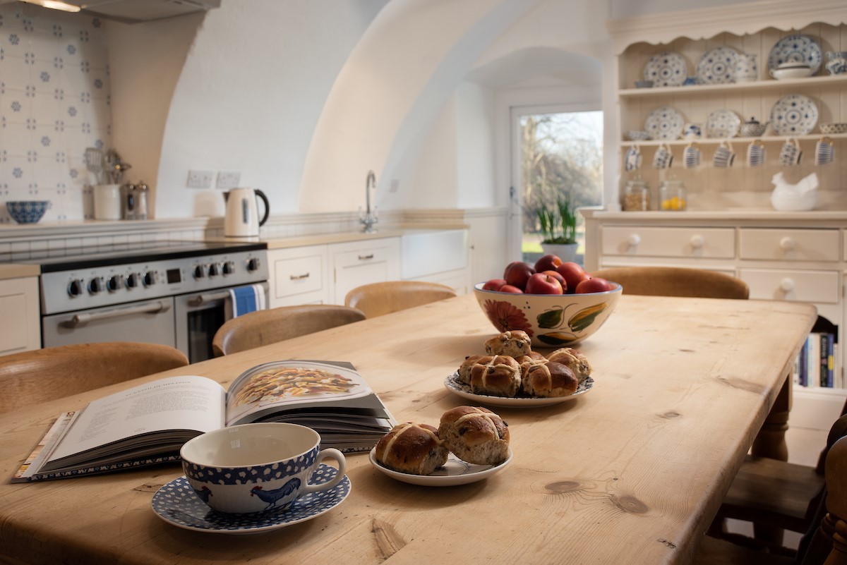 The Tower, Keith Marischal - rustic kitchen table with room for eight, Cookmaster double oven and charming dresser dotted with blue and white crockery