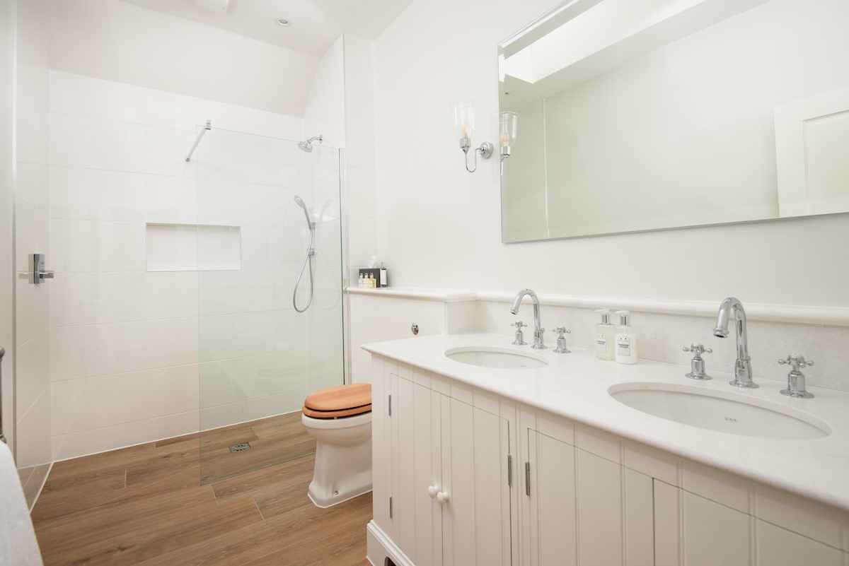 Hillside Cottage - en suite bathroom with walk-in shower with hand-held shower attachment, WC, heated towel rail and double basin