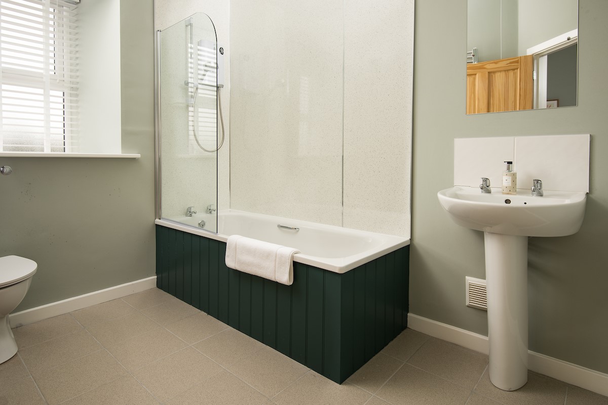 The Rushes - en suite bathroom of bedroom two featuring a bath with overhead shower