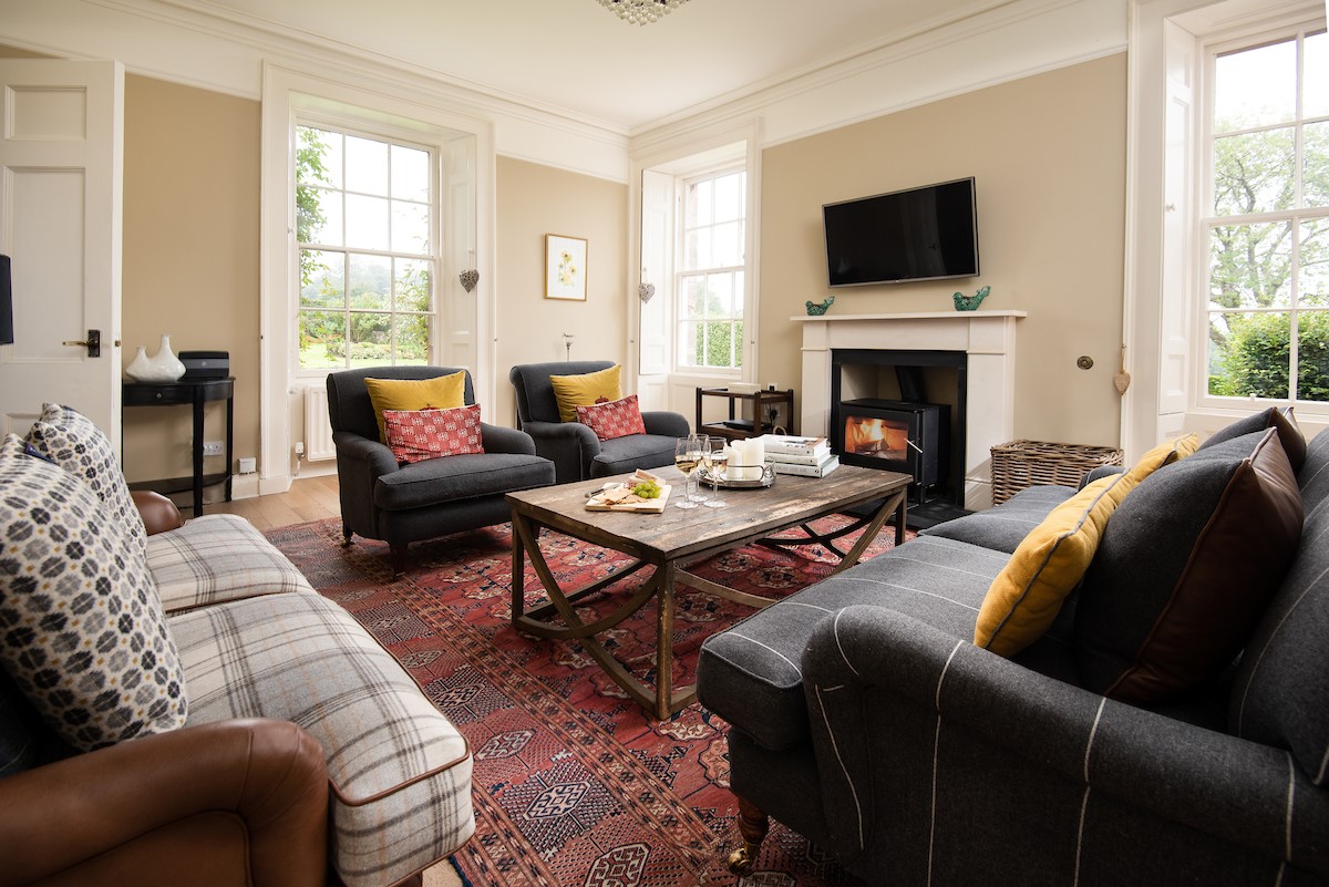 Seaview House - ample seating in the sitting room with cosy wood burner