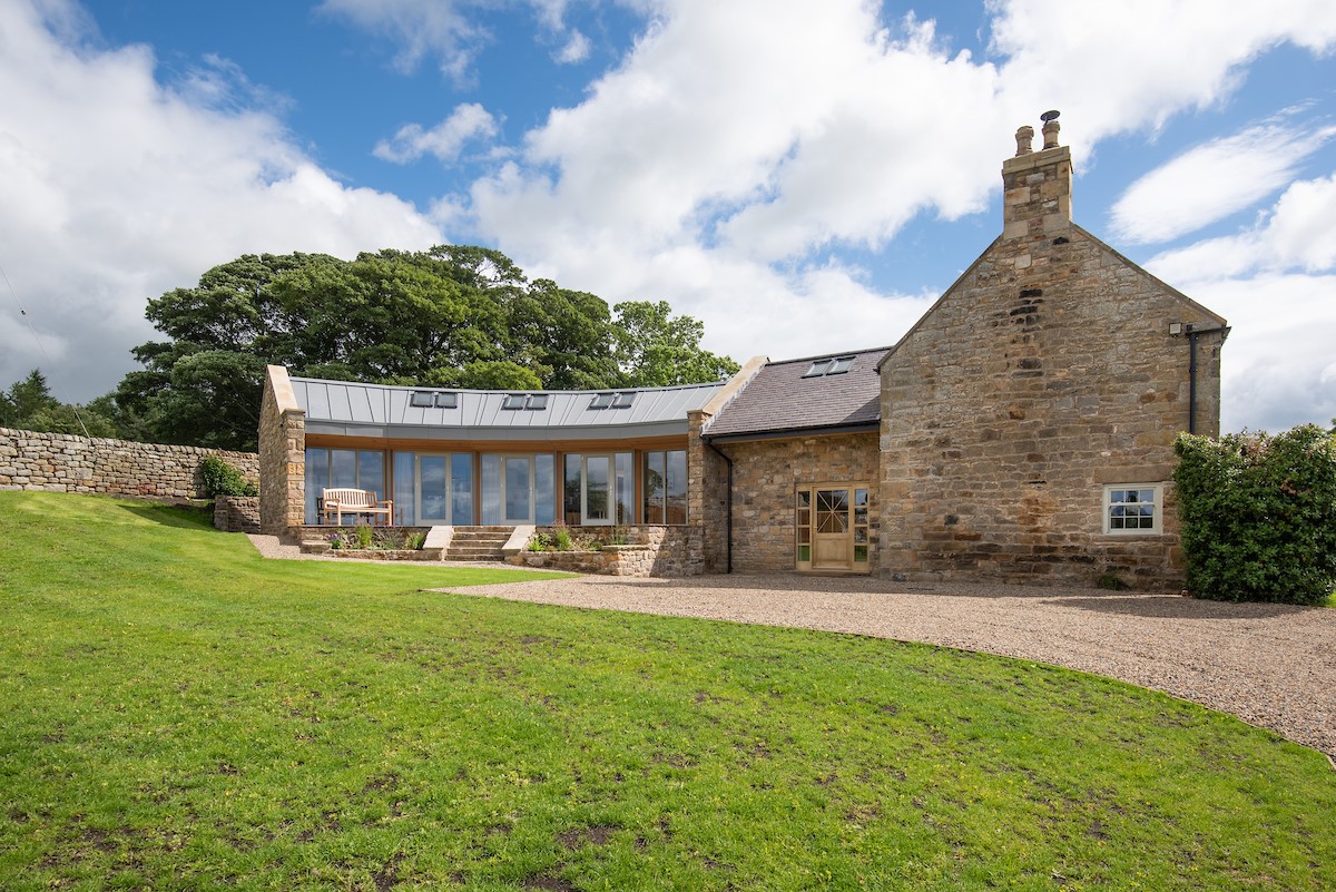 Shepherd's House - gravelled driveway with raised patio and lawn to the front of the property