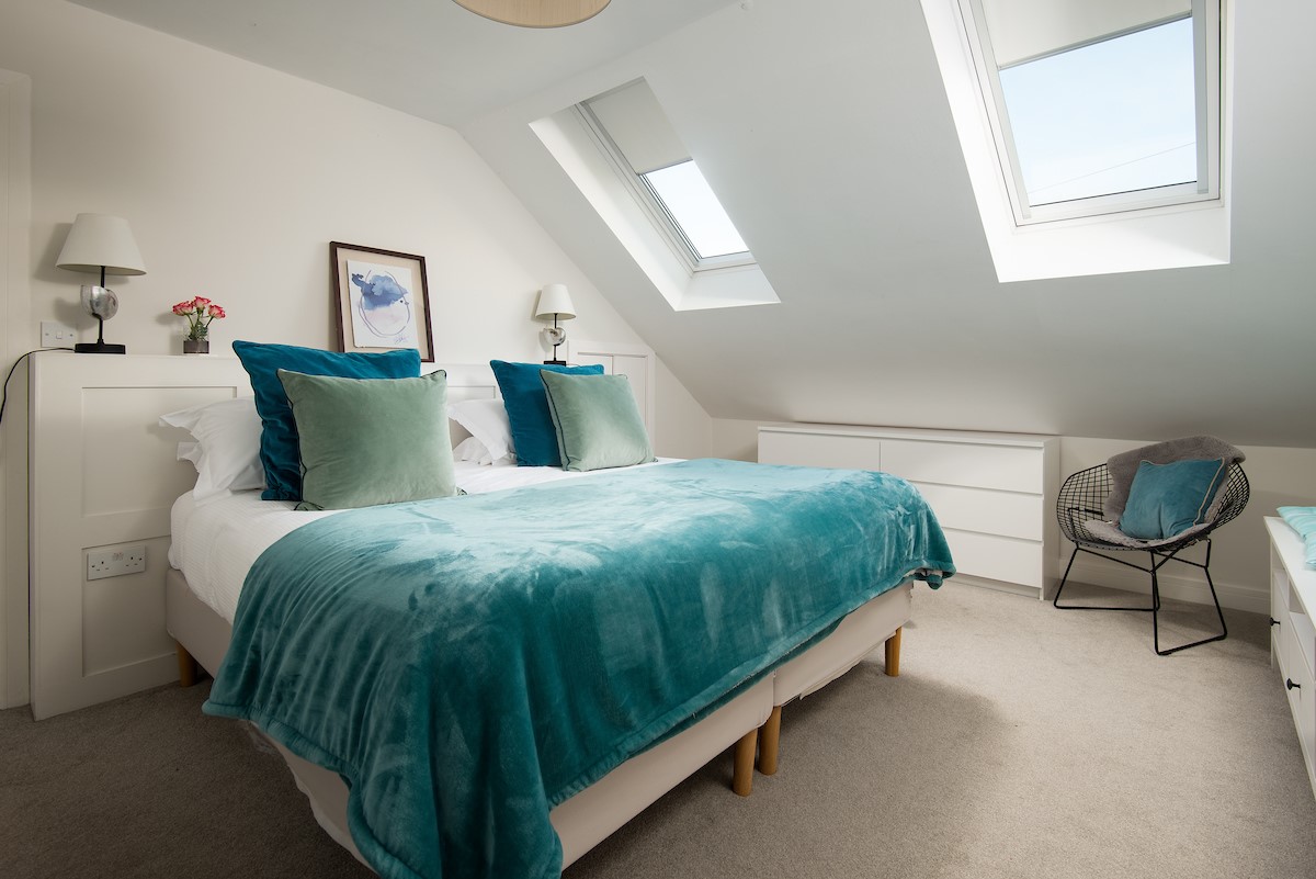 Duneside House - bedroom one with super king size bed and Velux windows