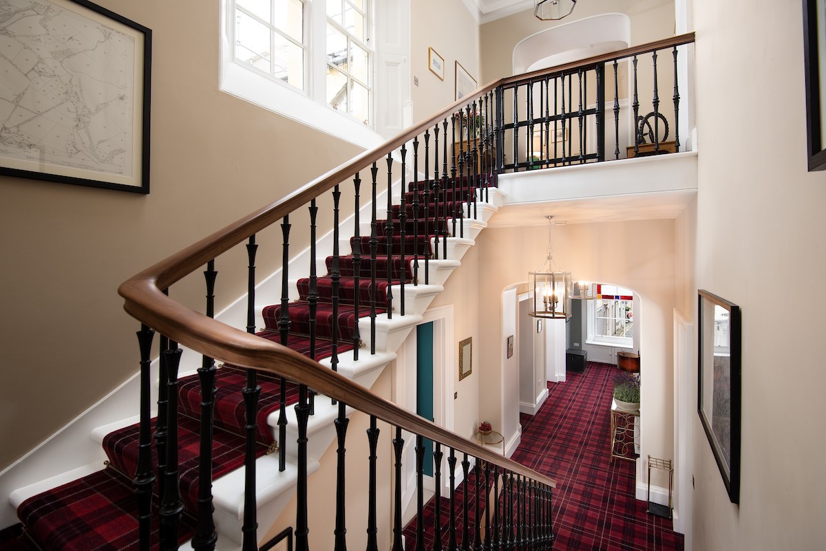 The Linen House - grand double-turn staircase leading to the second floor