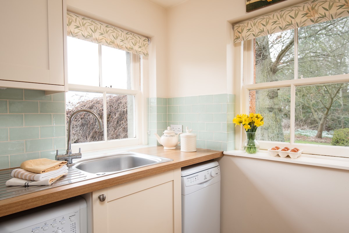 Daffodil Cottage - the kitchen with views over the grounds