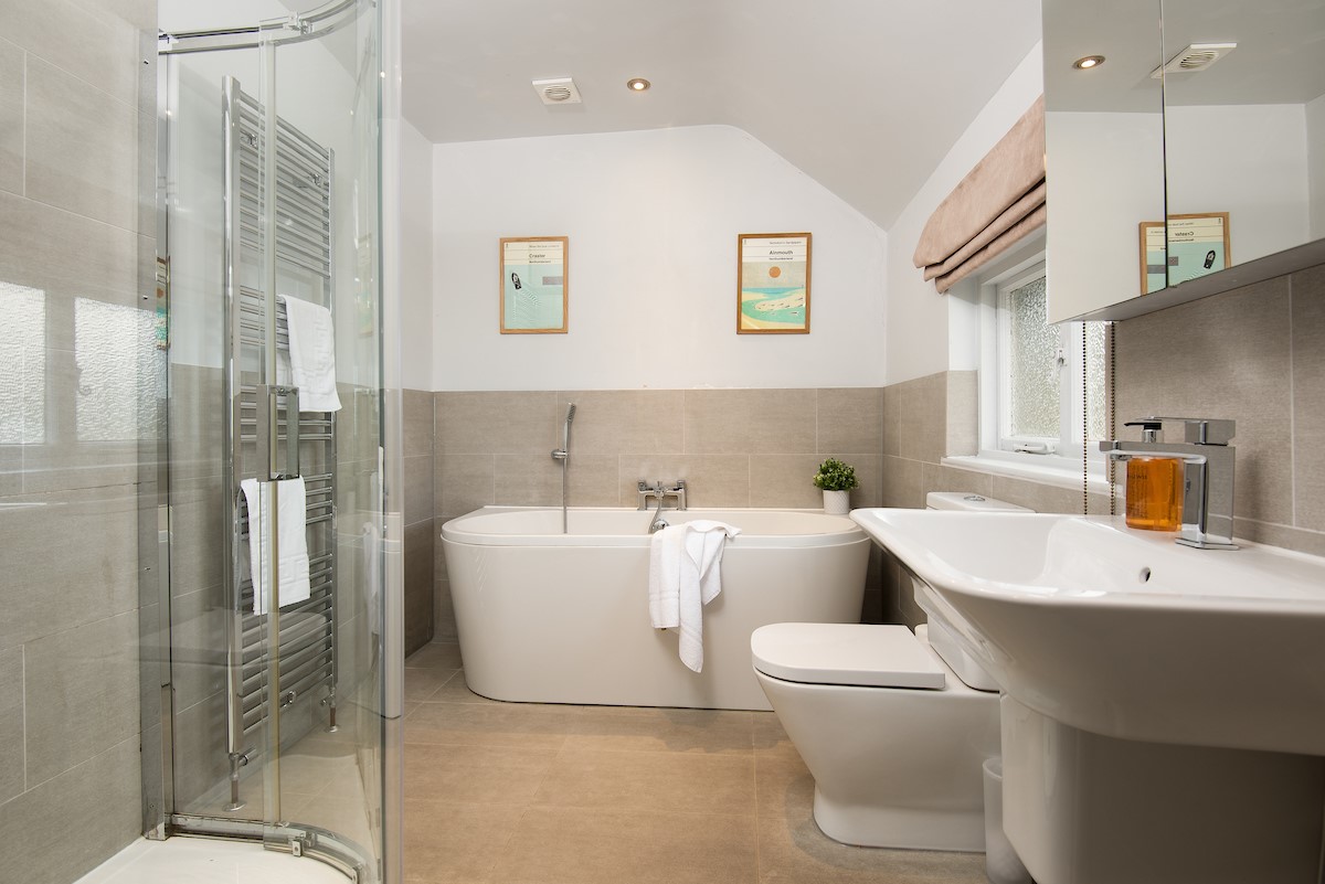 Cuthbert House - family bathroom with large bath with handheld shower attachment