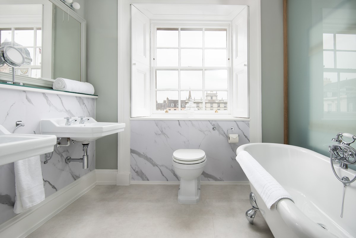 The Linen House - bedroom one's en suite benefits from double sinks and a freestanding slipper bath