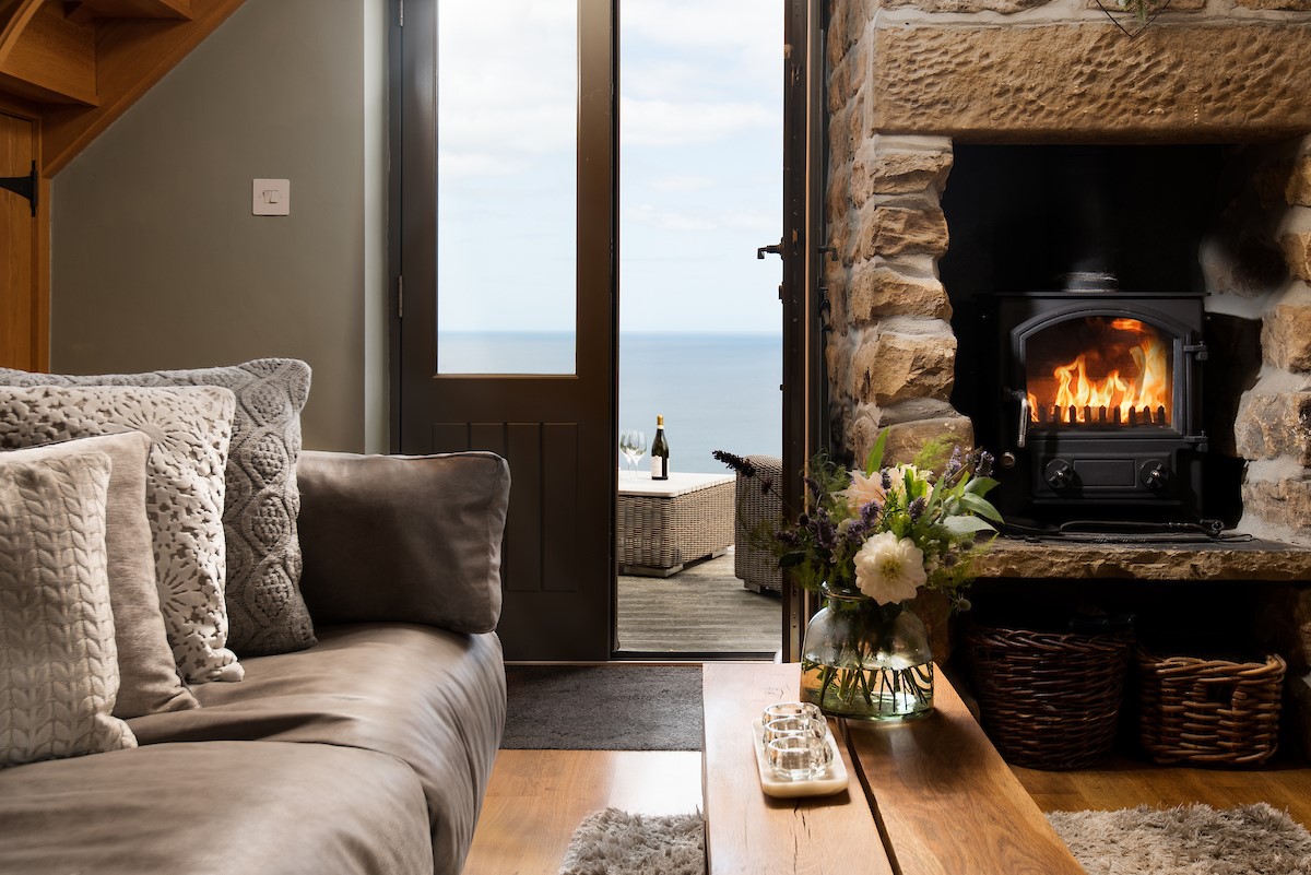 Bay View Cottage - cosy woodburning stove area with spectacular sea views